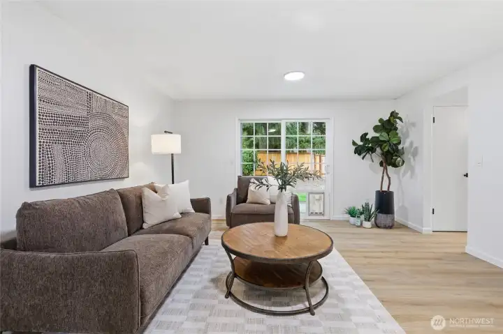 Third perspective shows the sliding glass door to the backyard and the room's generous size, well-suited for relaxed everyday living.