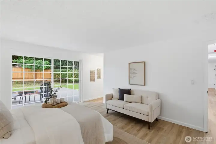 Alternate angle showcases the room's generous proportions and direct access to the backyard through oversized sliding glass doors.