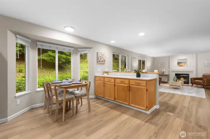 Light-filled kitchen opens the great room overlooking the forested backyard