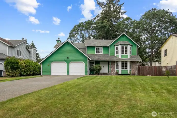 Welcome to Oakbrook! Two car garage with ample driveway parking and RV parking behind the gate.