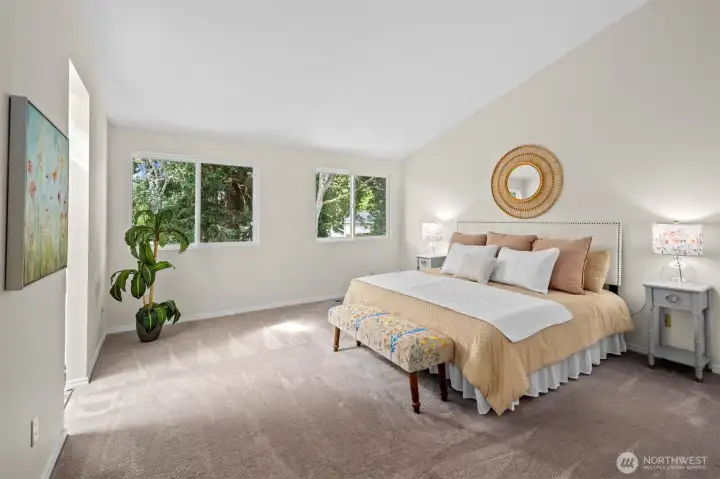Primary suite features vaulted ceilings and plenty of space for all your furniture.
