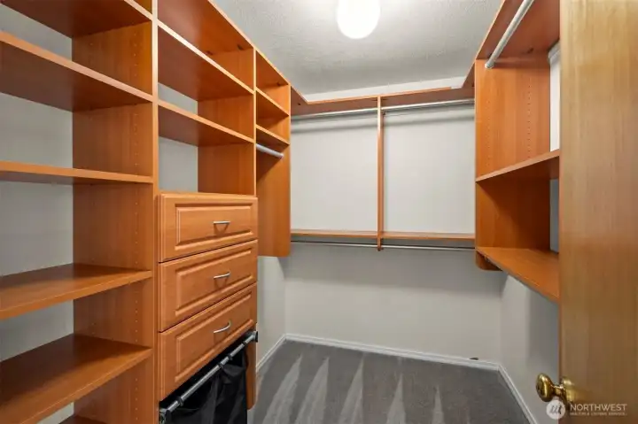 Custom built walk-in closet within the primary bedroom suite.