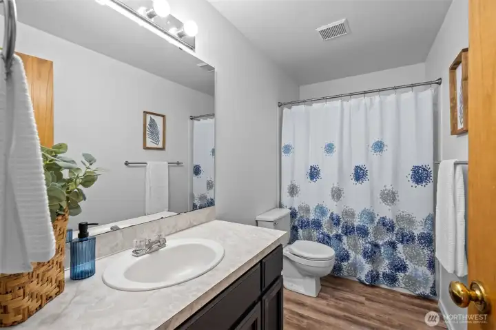 Upstairs hall bath is located close to the bedrooms.