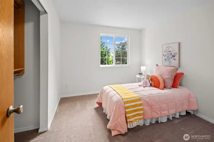 Another bedroom featuring a custom closet.