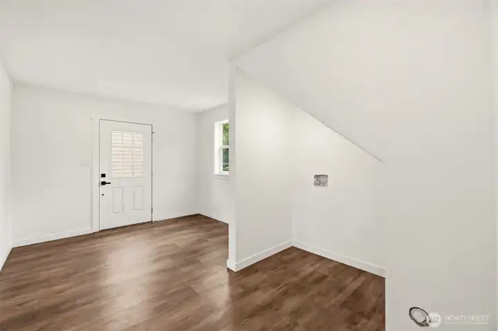 On the main level, just through the living room is a full mudroom. Already plumbed for an additional W/D. Good potential for an additional bathroom (buyer to verify.)