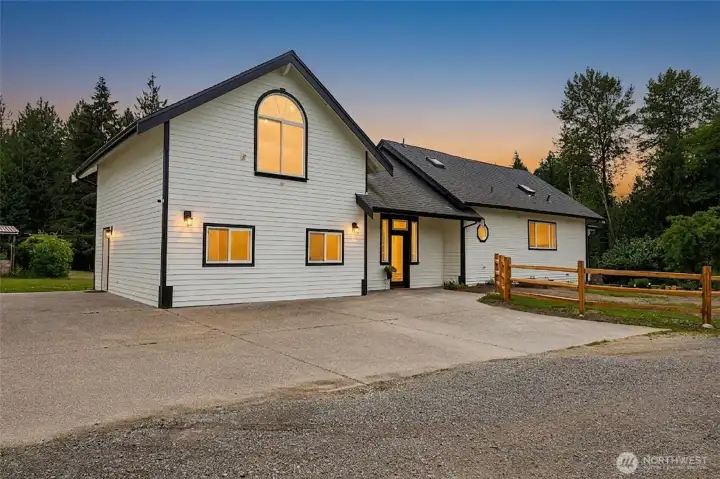 A view from the side of the home, with ample parking for all your vehicles, toys, RV's...etc. This can also be used as the main entry for the home.