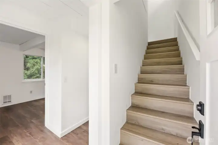 Stairs lead up to the main living/kitchen/ and 3/4 bathroom.