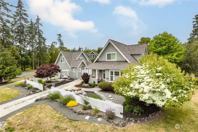 Mature plantings including flowering trees and some drought-resistant plants.