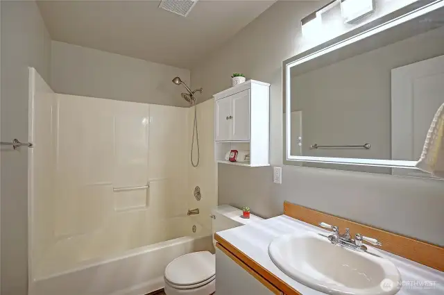 The Full bath in the hallway features a smart mirror with 3 lighting settings and heat.  Very simple and tasteful.