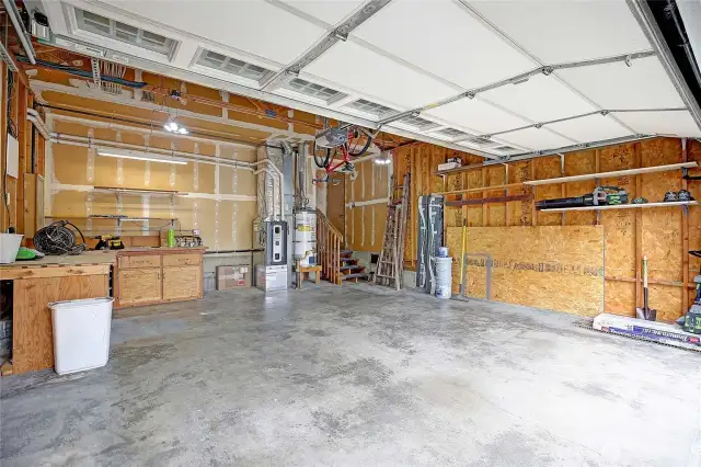 Oversized 2 car garage!  Room for work benches, ample shelving and storage above.  The garage is home to the Furnace with electric filter and the Hot Water Tank (gas piped) with water shock absorber.