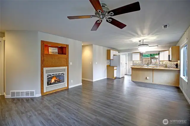 Wonderfully warm space just waiting for your personal touches.  Customized fireplace shelf with lights ready to feature your special treasures. Beautiful textured vinyl flooring throughout whole house except brand new carpeted bedrooms.