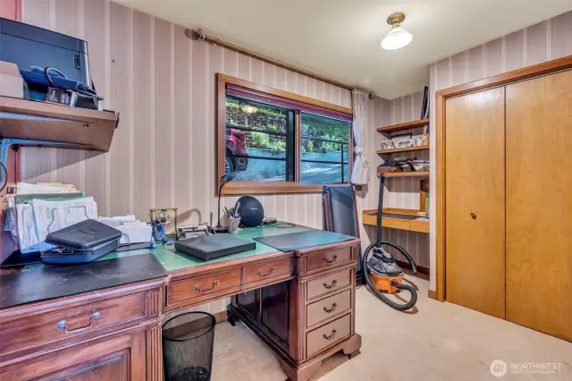 Bedroom 2 on main floor with built-in desk and shelving