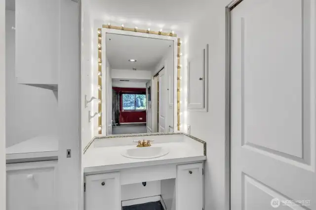 2nd primary suite on lower level has this vanity, separate from the deluxe show and commodes.
