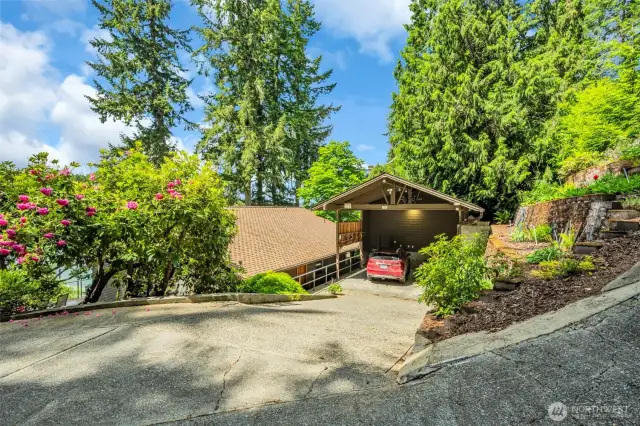 Oversized carport with mature landscaping, sprinkler system with terraced gardens