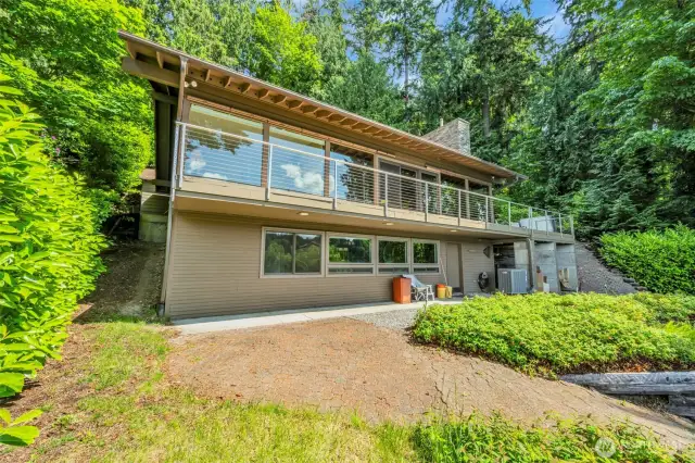 Exterior lower level under the deck, has 2 carport areas one for the ATV and one for firewood storage. Generator included.
