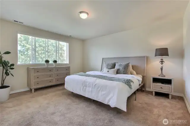 The primary bedroom is tucked away in the corner at the back of the home, offering a spacious, comfortable, and private retreat. Its quiet location ensures peaceful relaxation away from the main living areas. With plenty of room to unwind, it’s the perfect sanctuary to call your own. Privacy and comfort come together beautifully in this inviting space.