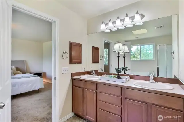 The primary bath features a double sink vanity, offering plenty of space and convenience for two. Just steps away, a large walk-in closet provides ample storage, completing this private retreat.  It’s the perfect space to start and end your day in comfort and style.