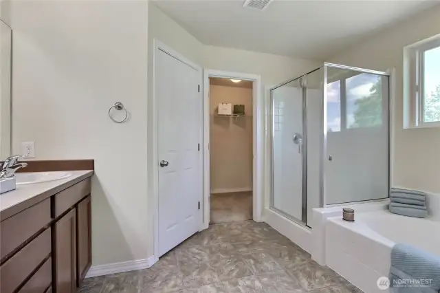 The primary bath is very spacious and filled with an abundance of natural light, creating a bright and serene atmosphere. It features a soaking tub, perfect for unwinding after a long day. Thoughtfully designed for comfort and relaxation.