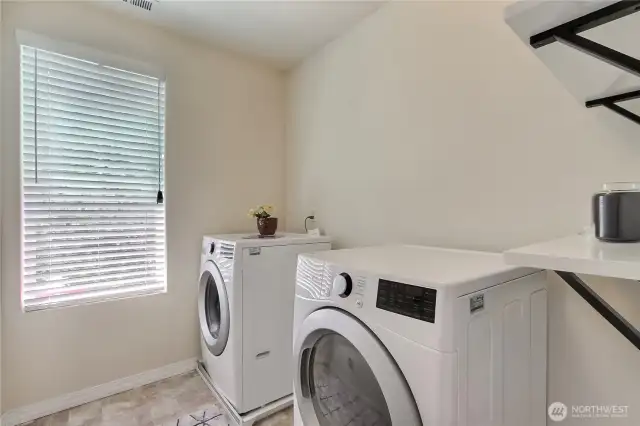 The well-lit laundry room offers a bright and functional space. Thoughtfully designed for convenience, this laundry area adds real value to your daily routine