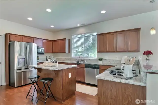 The kitchen is modern and bright, offering abundant counter space that makes cooking a breeze. Its open layout allows for easy movement, whether you’re preparing a quick meal or hosting a gathering. It’s a space designed to make everyday living feel effortless.