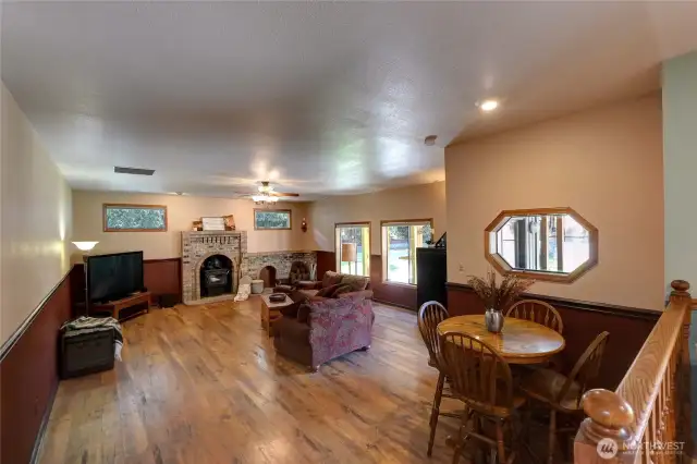 Family Room Designed For Both Relaxation & Entertaining. Featuring Large Windows, Rich Laminate Hardwood Floors, & Striking Wall Fireplace-All Creating a Timeless Style That's Truly Hard To Find.