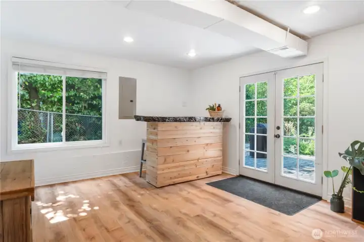 French doors lead to cobblestone back patio with pergola, space to roam and designated firepit area