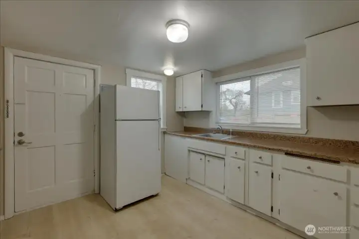 Unit #4 Kitchen shot. Again, fresh paint and water proof vinyl plank flooring! New blinds and cabinets repainted.