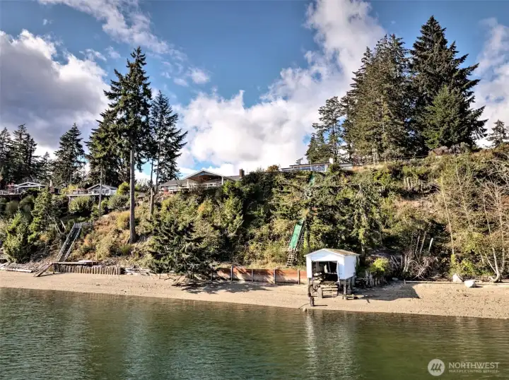 Beach stairs, new bulkhead, boat house, gravel beach.