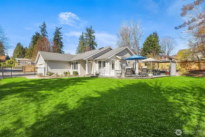 A beautifully designed outdoor retreat takes center stage in this sunny, light-filled rambler set at the end of a quiet private road in Brier