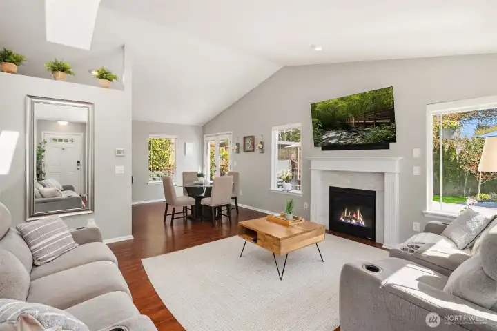 Cathedral ceilings, gorgeous hardwood floors and expansive windows fill this space with amazing light