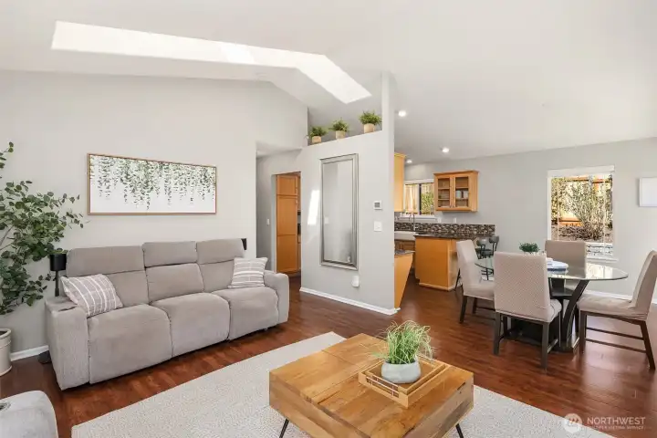 Cathedral ceilings, gorgeous hardwood floors make the living and dining rooms live large