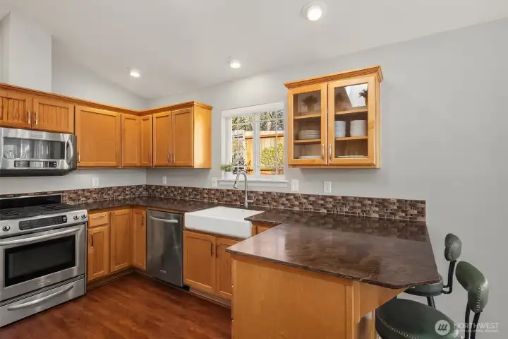 Gorgeous chef's kitchen with plenty of cabinet space, granite countertops and a beautiful eating bar that opens to the dining and living rooms