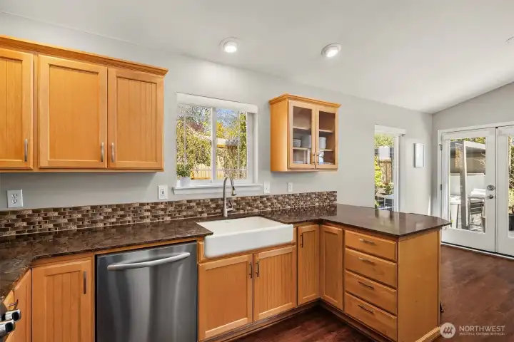 Gorgeous chef's kitchen with plenty of cabinet space, granite countertops and a beautiful eating bar that opens to the dining and living rooms