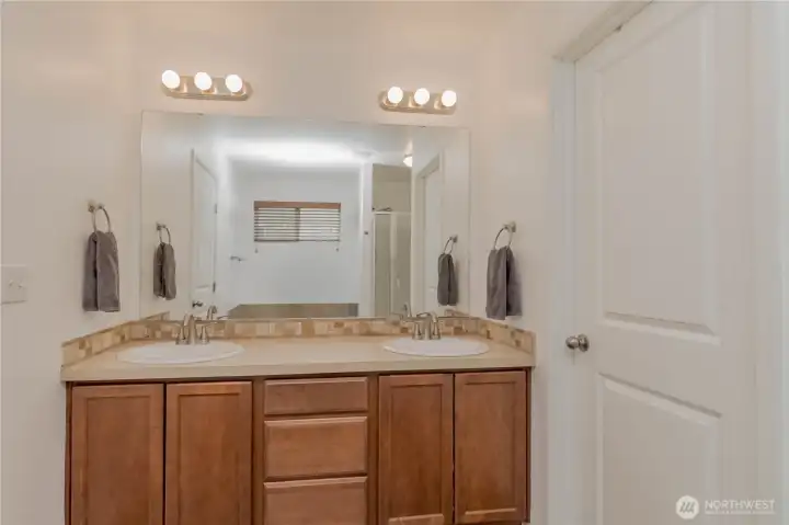 Great primary bathroom space with new sinks, hardware and lighting