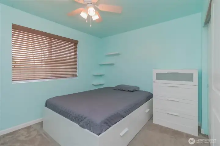 Bedroom #2 with fun aqua paint energy and view of the back yard