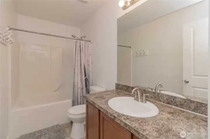 Main full bathroom upstairs with new sink, hardware, light and toilet