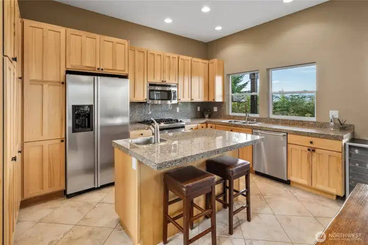 Designed for gathering, the kitchen pairs beautiful hickory cabinetry and granite tile countertops with expansive mountain views.