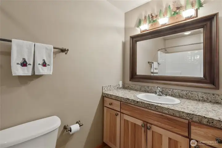 A well-appointed full hall bath conveniently serves the two upper-level guest bedrooms.