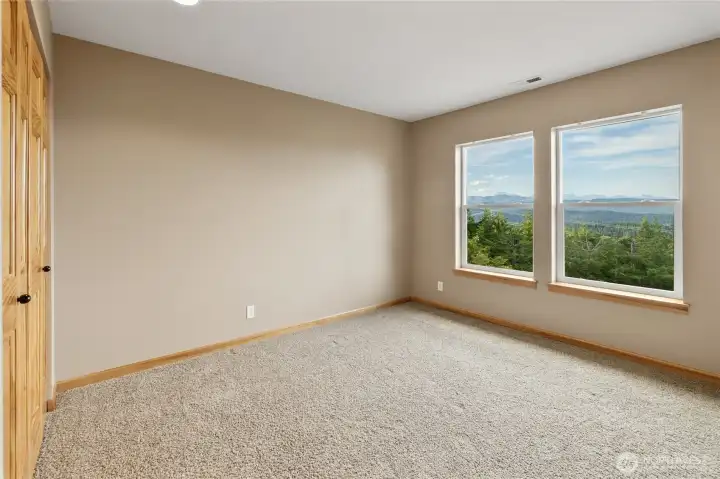Your guests will appreciate the breathtaking mountain and territorial views from this inviting bedroom.