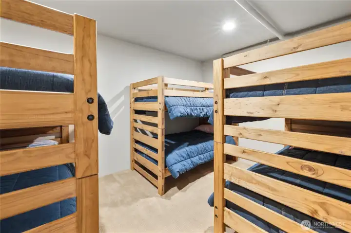 Whether hosting a ski weekend or summer getaway, the lower-level bunk room/bonus room provides comfortable accommodations for a crowd.