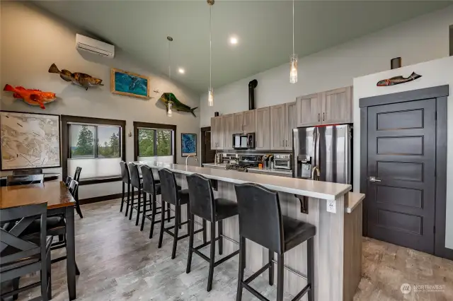 Kitchen Bar seats 6 comfortably. All countertops are solid  surfaces with  matching cabinetry, Island has a dual zone beverage cooler, touchless faucet & bar sink, Pendant lighting, kitchen also has On-demand hot water,  with programable circulation, LG stainless appliances, 5 burner gas stove, dual oven, side by side fridge w/twin door freezer, tile backsplash, under cabinet lighting, & much more!