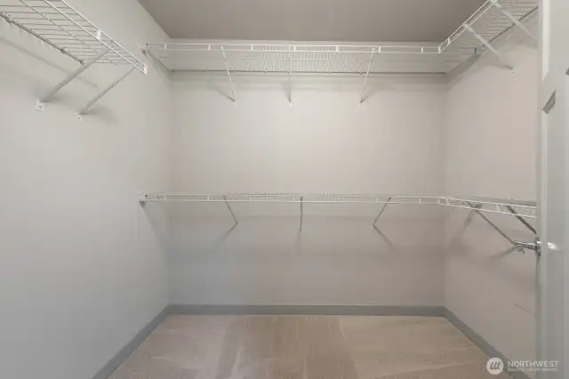 Spacious walk-in closet within the primary bedroom.