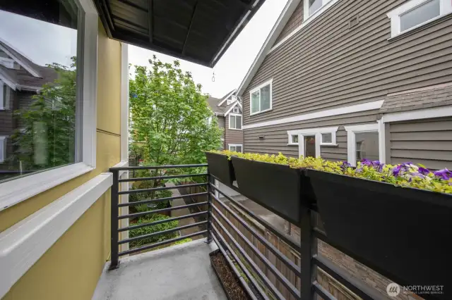 Private balcony with custom planters, ideal for sipping coffee or growing herbs and flowers.