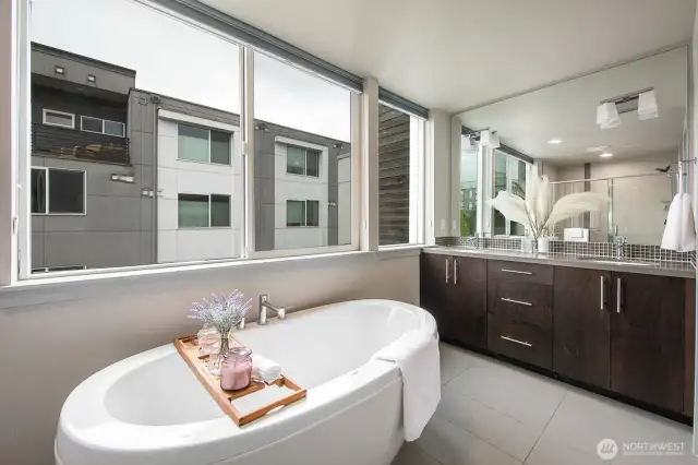 Spa-inspired bath featuring a soaking tub, double vanity, and generous natural light.