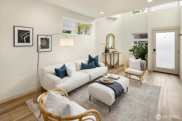 The main living area with 20 ft ceilings includes an abundance of natural light.