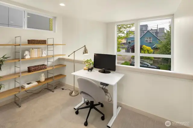 This second floor loft space looks over the main living area and is ideal for an office, workout area, or  general flex space.