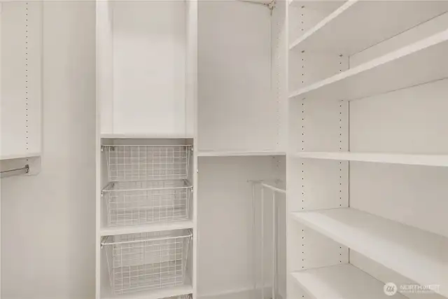 Walk-in closet with shelving system.
