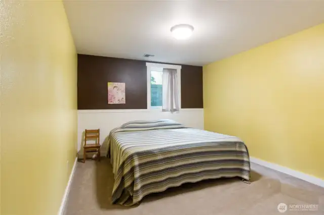 A comfortable and bright bedroom offering flexible use as a guest room or personal retreat. Conveniently located in the basement living area with easy access to nearby bath and laundry facilities.