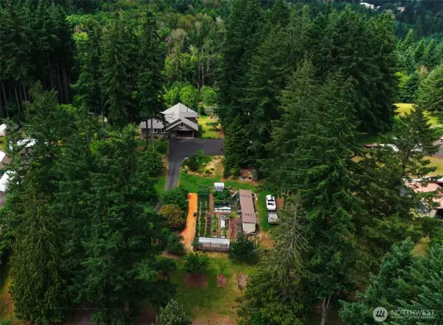 Aerial View showcasing the beautiful natural setting and the expansive footprint of the home, this overhead perspective highlights the peaceful privacy and spacious layout that make this property truly special.