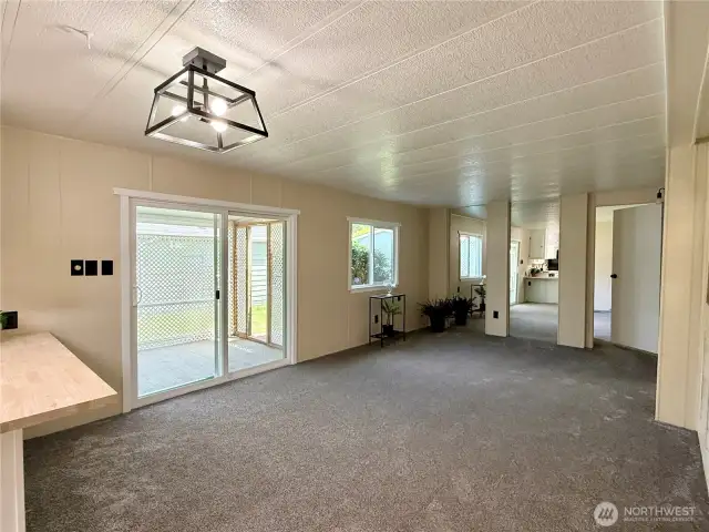 Standing by the kitchen is a view of the family room.